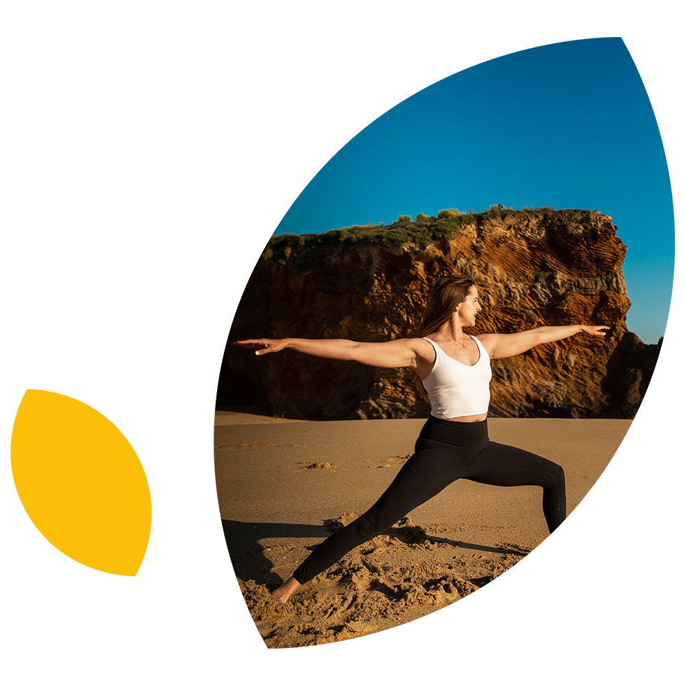 Person doing yoga on the beach
